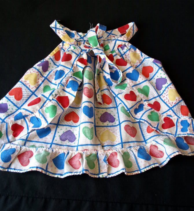 50% cotton, 50% polyester. Very soft, cutest heart print Ruffled trim 