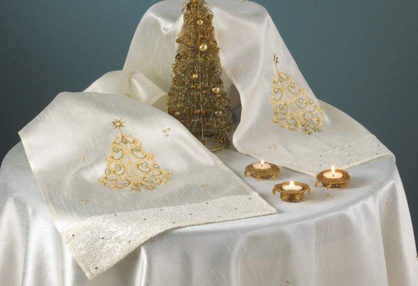 This beautiful table runner features an embroidered and cutwork star 